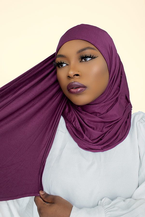 Woman gracefully draping the instant premium jersey hijab in a timeless hijab style, perfect for any occasion