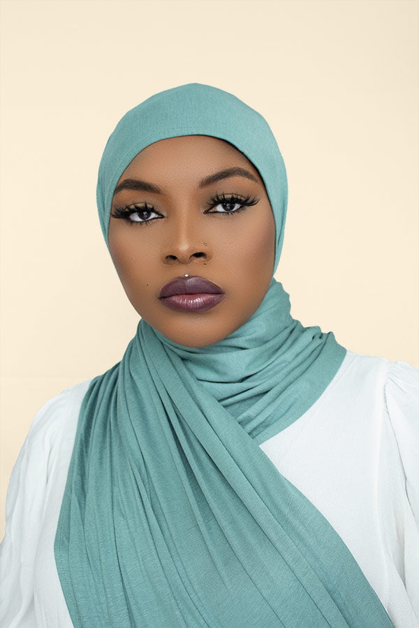 Woman gracefully draping the instant premium jersey hijab in a timeless hijab style, perfect for any occasion