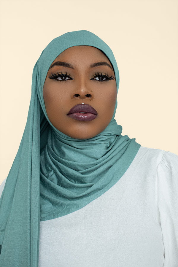 Woman gracefully draping the instant premium jersey hijab in a timeless hijab style, perfect for any occasion