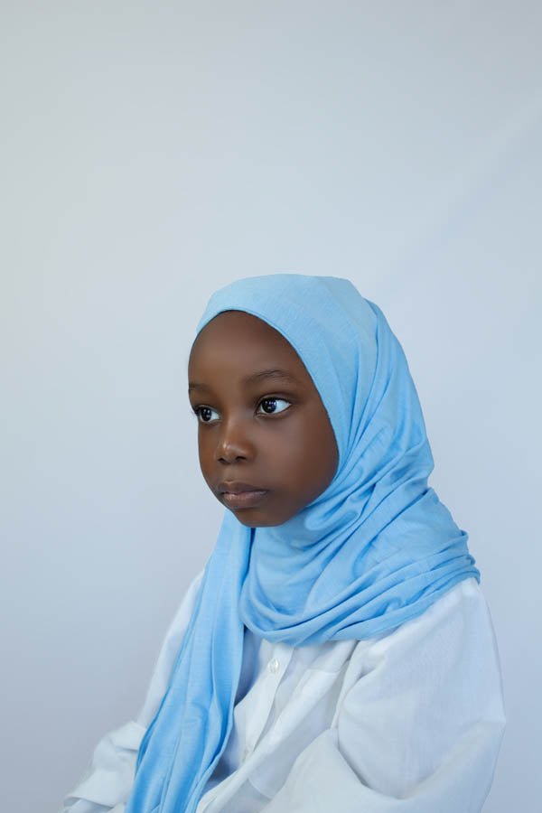 little girl is wearing blue instant jersey hijab