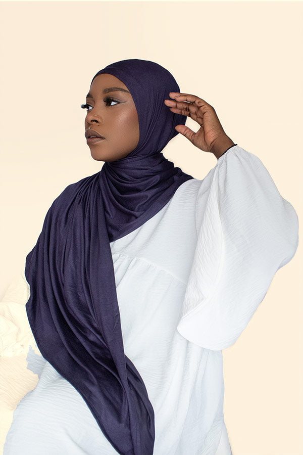 Woman gracefully draping the instant premium jersey hijab in a timeless hijab style, perfect for any occasion