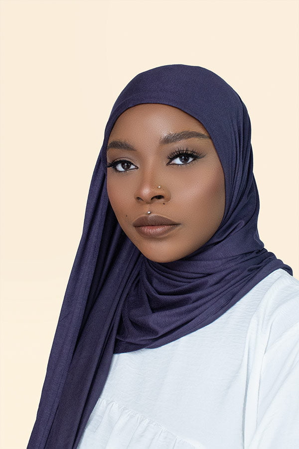 Woman gracefully draping the instant premium jersey hijab in a timeless hijab style, perfect for any occasion