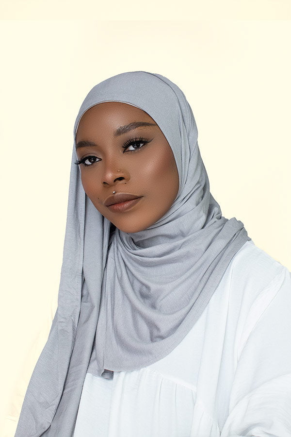 Woman gracefully draping the instant premium jersey hijab in a timeless hijab style, perfect for any occasion